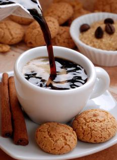 coffee-being-poured-into-white-cup-near-cookies.jpg