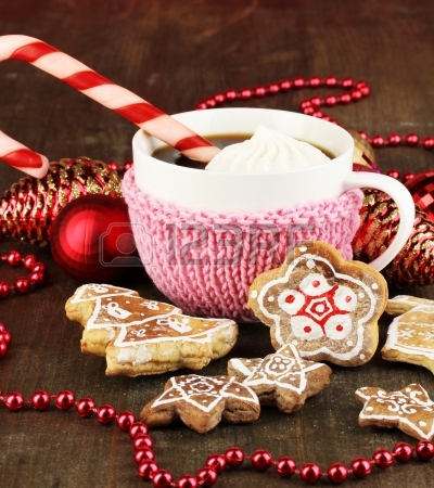 17054457-cup-of-coffee-with-christmas-sweetness-on-wooden-table-on-red-bokeh-background.jpg